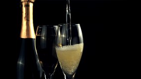 Champagne is poured into the glass with a whirlpool with air bubbles. On a black background. Filmed is slow motion 1000 fps. High quality FullHD footage - Powered by Shutterstock - Get 15% off with code: PIKWIZARD15