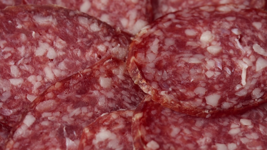 Sliced raw smoked salami sausage spun as a restaurant backdrop, fresh cured sausage for a sandwich | Shutterstock HD Video #1082175767