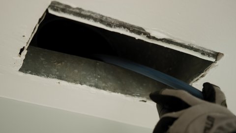 Home Duct Cleaning Services, ventilation cleaner man at work with tool. Slow motion.