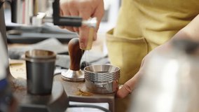 Close up of barista hands making coffee with coffee machine working in coffee shop, 4k video footage