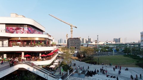 Shanghai, China - Nov. 11, 2021: Time lapse footage of crowded people walking in Qiantan, Taiguli, new shopping mall and landmark in Shanghai.