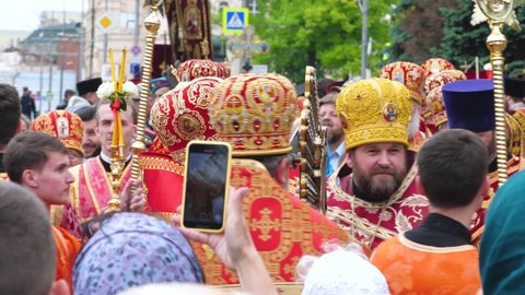KHARKIV, UKRAINE - JUNE 1, 2021: Christian procession is organized walking ceremonial manner. Processional banners and icons, choir and clergy, deacons with censers, priests with icons, faithful. 