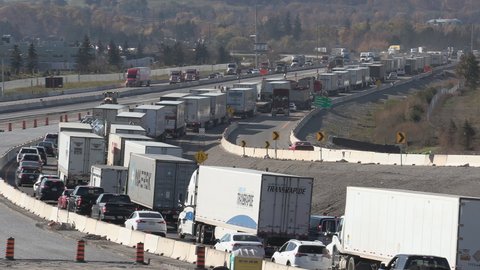 Milton, Ontario, Canada October 2021 Epic Semi truck tractor trailer traffic jam and highway gridlock
