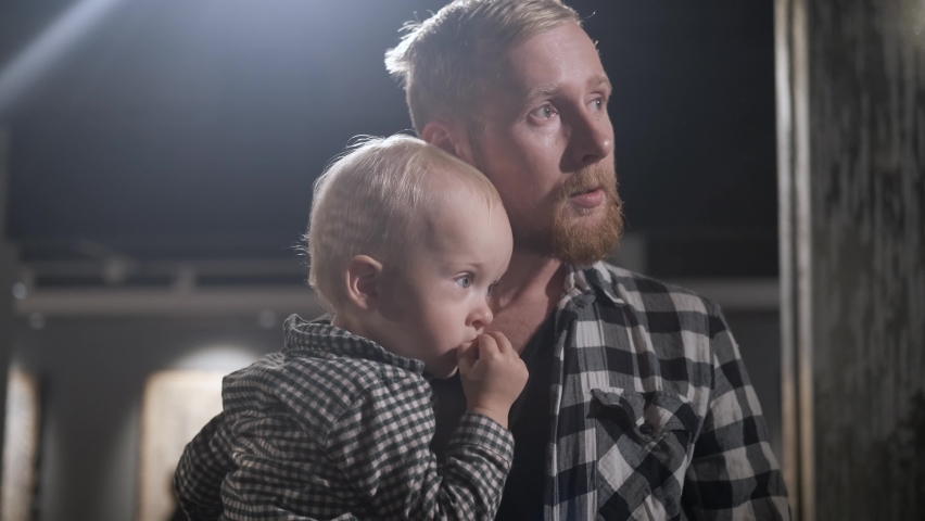 father and little son are discussing an exhibition in the museum