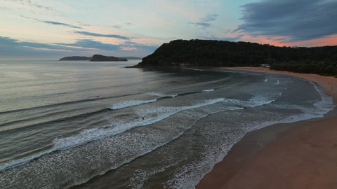 Sunrise at the seaside with clouds and gentle sea at Umina Beach on the Central Coast, NSW, Australia.