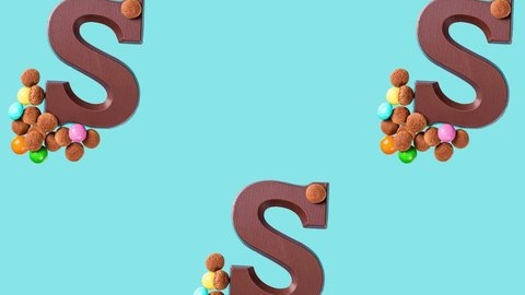 Festive collage with chocolate letter S, kruidnoten cookies and traditional hollands sweets. Dutch holiday Sinterklaas background. FullHD video
