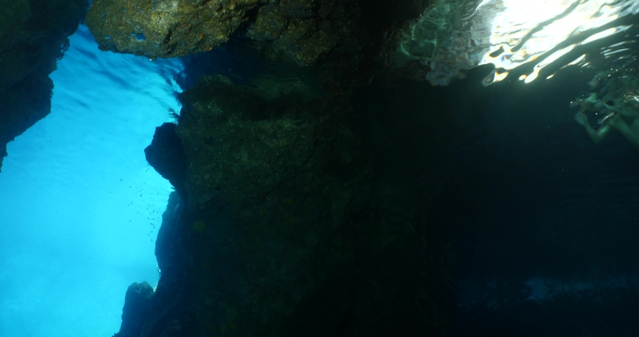 free diver in a cave underwater going out of the cave in blue light ocean topography and human scenery of sports Royalty-Free Stock Footage #1082201660