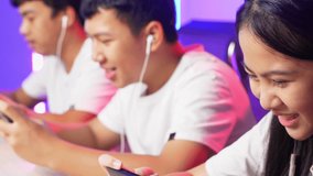 Close Up Team Of Asian Esport Gamers Playing In Competitive Video Games On A Cyber Games Tournament By Mobile Phone
