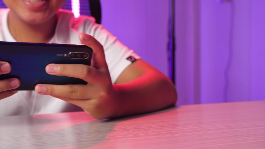 Hands Of Asian Esport Team Gamers Playing In Competitive Video Games On A Cyber Games Tournament By Mobile Phone
