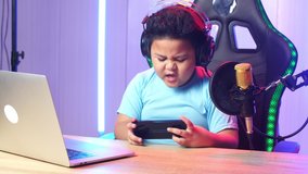 Asian Little Boy Playing Video Game With Mobile Phone Then Lose The Game And Talking To Camera While Live Stream 
