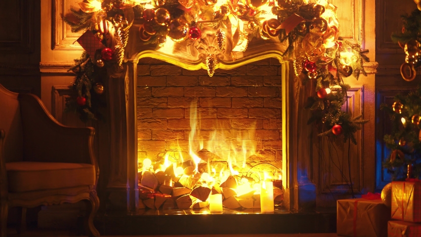 Fireplace with burning fire. Christmas and New Year interior decoration. Green tree decorated with toys, gifts, present boxes, flashing garland, illuminated lamps. Cozy Christmas atmosphere. 4K Loop | Shutterstock HD Video #1082210681