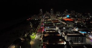 5k aerial Miami Beach ocean drive destination with neon lights