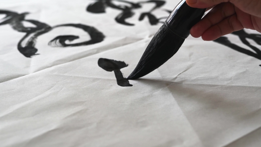 An old calligrapher is writing calligraphy and writing calligraphy. Translation: Sense of time sees the moon, and the city is deep in spring. Royalty-Free Stock Footage #1082212250