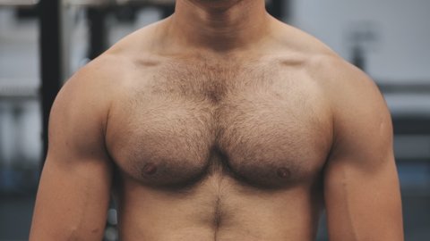 A man moves his strong and muscular chest