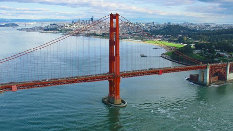 Aerial view of the Golden Gate Bridge San Francisco California. United States. It connects the San Francisco peninsula to Marin County. US route 101 and SR 1 full of cars. City skyline.