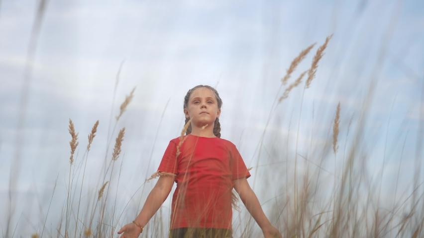 kid pray. pulls hands against a sky. child girl concept faith religion and happy family. kid girl pray hands to the side against sky jew kid praying to god. lifestyle worship and gratitude religion