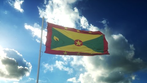 Flag of Grenada waving at wind against beautiful blue sky