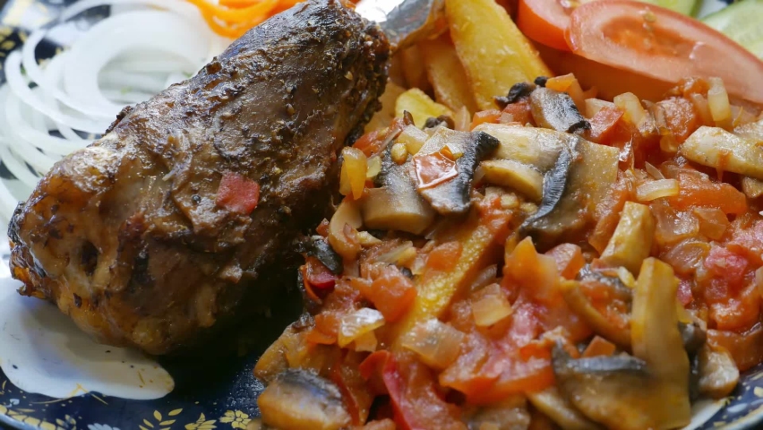 bone-in meat with vegetables on a plate
