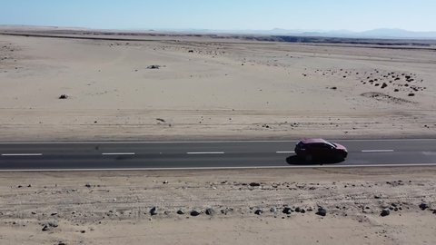 Atacama, Chile - December 2021: Car Driving Through Desert, Drone View, Drone Footage of Car Driving in Desert of Atacama, the Driest Nonpolar Desert in the World, Chile, South America.
