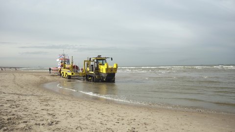 Katwijk , Zuid Holland , Netherlands - 10 02 2021: KNRM Lifeboat On Launch Vehicle By Coastline Of Beach