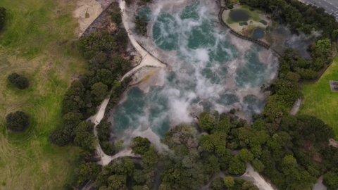 Drone flyover hot steaming spring and board walkaway in Kuirau Park, Rotorua, New Zealand