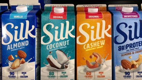 Edmonton, Canada - November 5, 2021: Various types of Silk brand milk, an alternative to dairy cow milk products, on display on a grocery store shelf