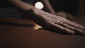 Quality leather. Tracking shot of male tailor hand smoothing fabric piece on table at workshop, close up - Powered by Shutterstock - Get 15% off with code: PIKWIZARD15