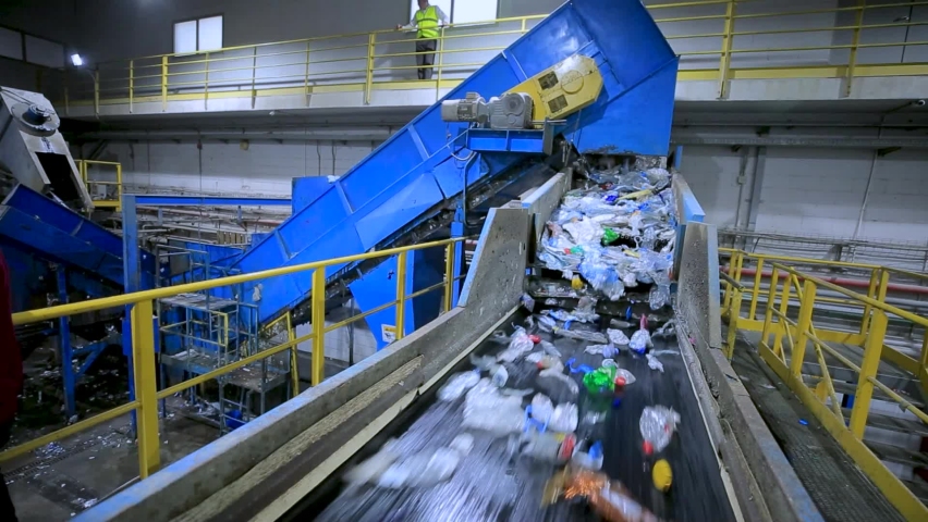 Plastic recycling plant. Conveyor with shredded plastic from PET bottles | Shutterstock HD Video #1082248547