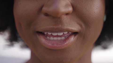 Close shot of females mouth talking directly to camera, vox pop style
