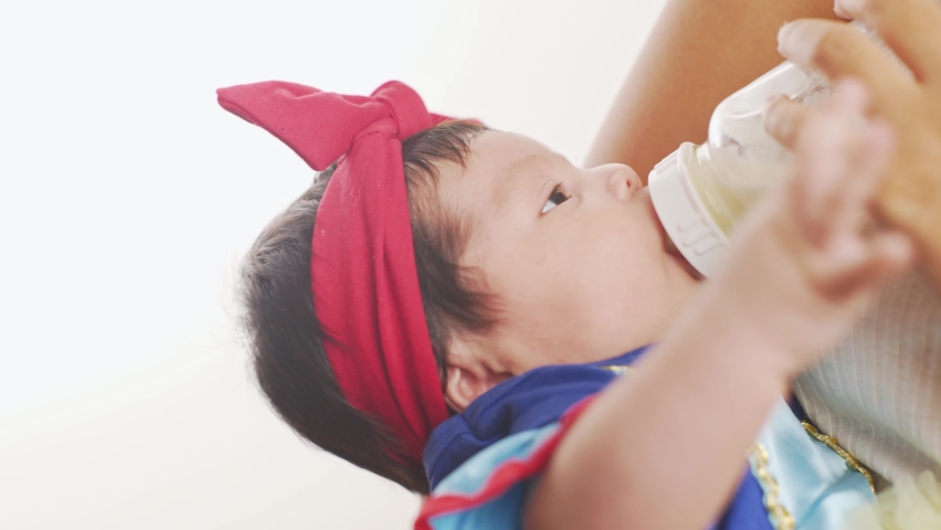maternity concept. young hispanic woman feeding her newborn daughter.