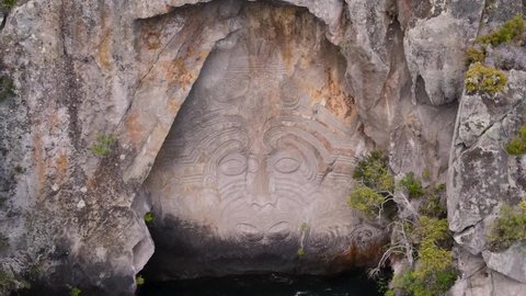 Carving of Ta Moko tattooed face, amazing piece of Maori art. Lake Taupo, New Zealand. Aerial close up