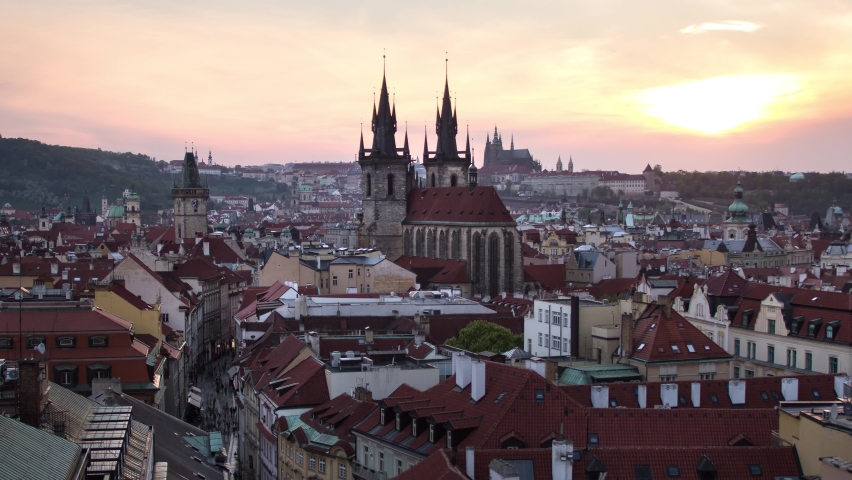 Day to night sunset timelapse of the Prašná Brána (Powder Tower), Old Town Hall, Prague Castle and downtown Prague, Czech Republic as it lights up during the night