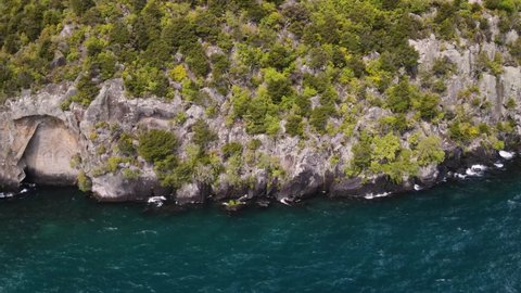 Aerial view of famous ta moko tattoed face, maori carving on rocky cliff, Lake Taupo, New Zealand