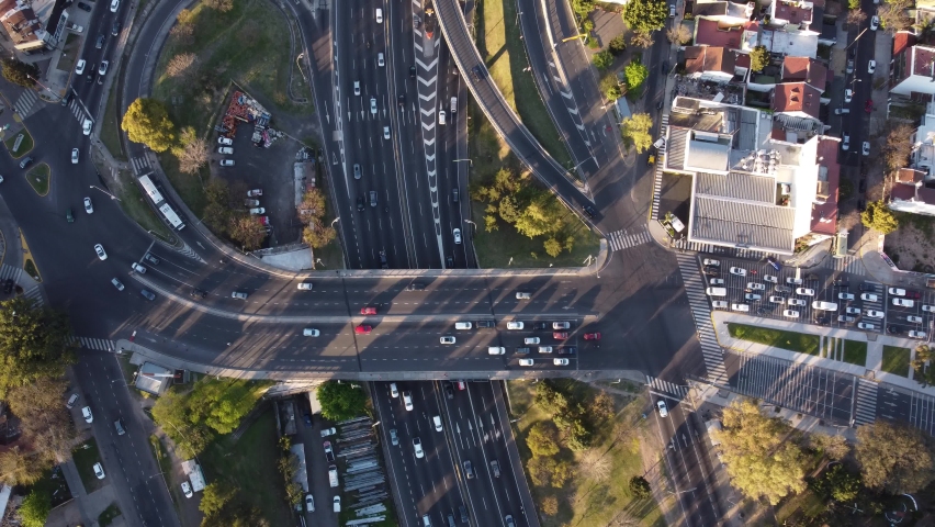 Aerial image of Unidentified cars passing fast over the Pan American highway in Buenos Aires, Argentina during day time.