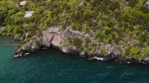 Lake Taupo Maori mask, carved in stone. Aerial view of New Zealand famous spot.