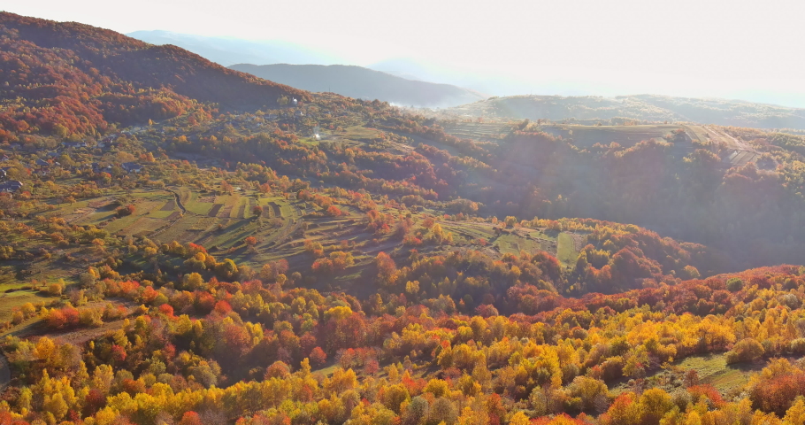 Aerial top view the autumn landscape in beautiful mountain valley with mountains with small houses