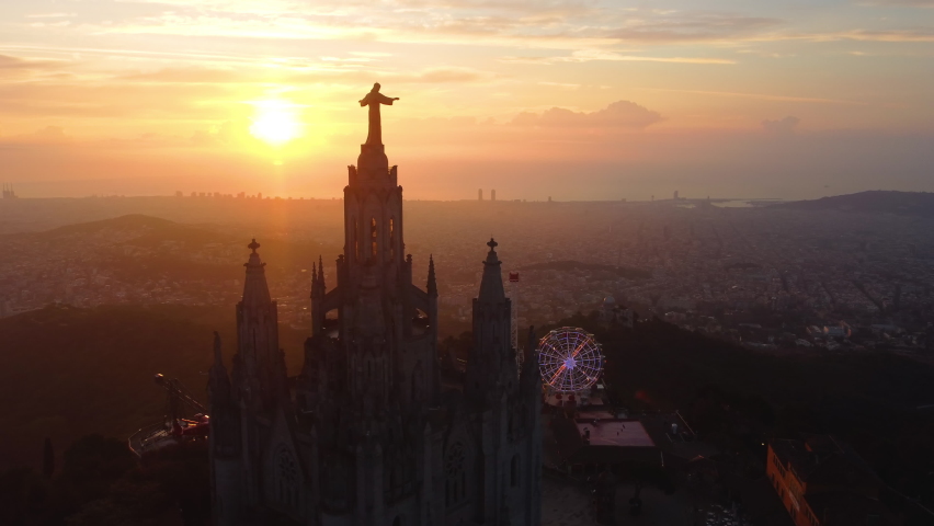 The top-view of the big statue of the Sacred Heart in the Temple of the Sacred Heart of Jesus, in Barcelona, Catalonia, Spain in the sunrise, UHD, 4K Royalty-Free Stock Footage #1082262806