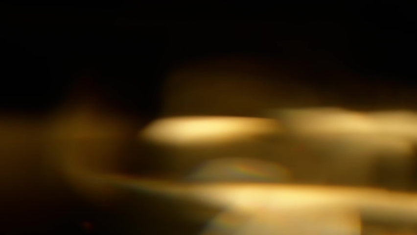Defocus circles of bokeh lights moving and blinking in night darkness.