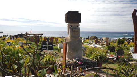 Easter Island, Chile - Nov 12 21: Moai statue on a cemetery in Rapa Nui, Easter Island, Chile. Antique and mysteriuos Moai statue symbol of an ancient culture.