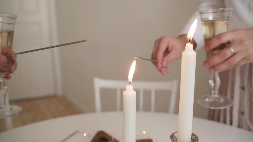 Slow motion two cheerful women with sparklers for Christmas with glasses of champagne and lights on the background. Happy new year. Christmas night. Happy family and celebrate