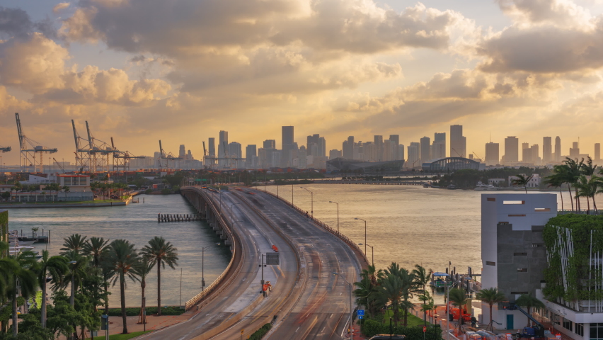Miami, Florida, USA downtown city skyline over The General Douglas MacArthur Causeway at dusk. Royalty-Free Stock Footage #1082273699