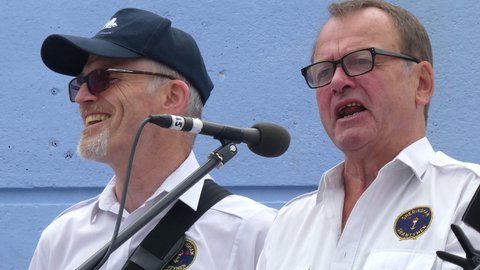 Sheringham, Norfolk, United Kingdom. August 12, 2018. The Sheringham Shantymen sing 'The Wellerman' song at Sheringham Lifeboat Day, at the Lifeboat Station.