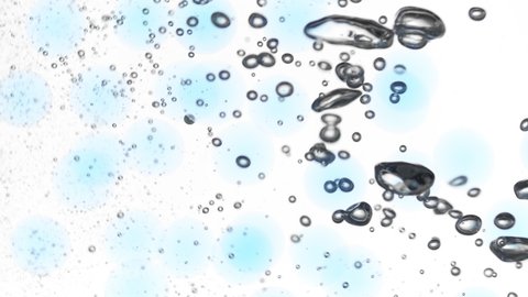 Different sized tiny grey bubbles of hyaluronic acid are moving spontaneously on white background with blue moving circles | Skincare cosmetics with hyaluronic acid background shot for its commercial