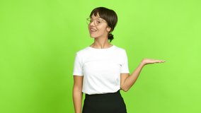 Young woman presenting something over isolated background. Green screen chroma key