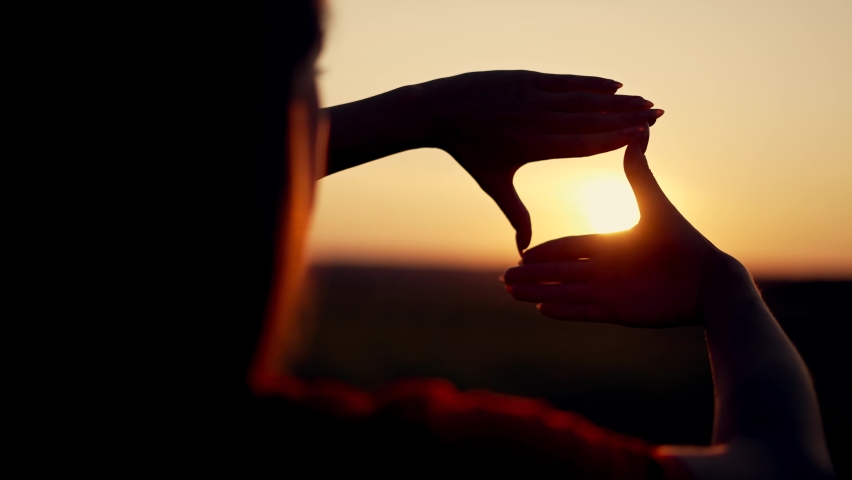Business strategy. Girl folded her hands in frame at sunset. Silhouette of girl in natural park. Fingers at sunset. Work planning. Girl in field folded her hands into frame. Business planning concept. Royalty-Free Stock Footage #1082300497