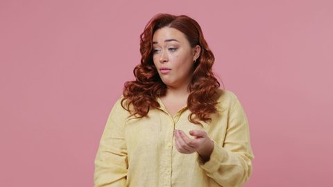 Displeased irritated dissatisfied boring†dull†tedious young ginger chubby overweight woman 20s wears yellow shirt applause cheering clapping hands isolated on plain pink background studio portrait