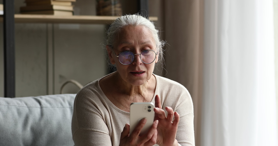 Excited joyful old age female discovered virtual activity world on retirement amazed with winning online interactive game on smartphone. Active mature lady pensioner get prize reward in web lottery | Shutterstock HD Video #1082309644