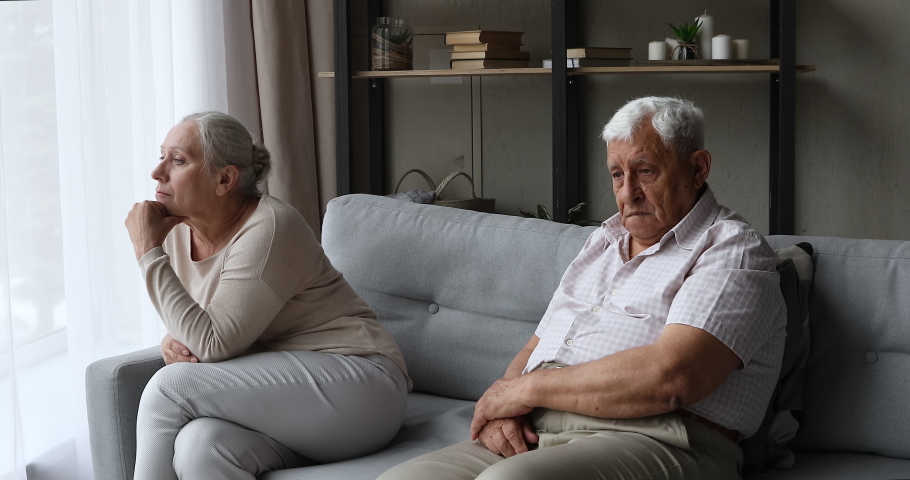 Sad resentful old age family couple sit on couch at living room separately feel offence misunderstanding avoid talking ignoring each other. Upset mature husband wife having problem in relationship | Shutterstock HD Video #1082309647
