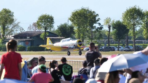 Udine Italy SEPTEMBER, 18, 2021 Radial engine propeller military vintage airplane landing in airshow with public. North American T-6 Texan or Harvard former Italian Air Force
