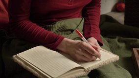 Woman writing some notes in a notebook in a bed. Pov view